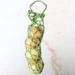 crochet onion holder with onions inside.