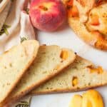 sliced peach sourdough bread with fresh peaches.