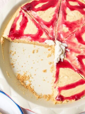 sliced peanut butter and jelly pie in a pie plate with some missing.