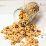 a jar spilling out homemade sourdough granola.