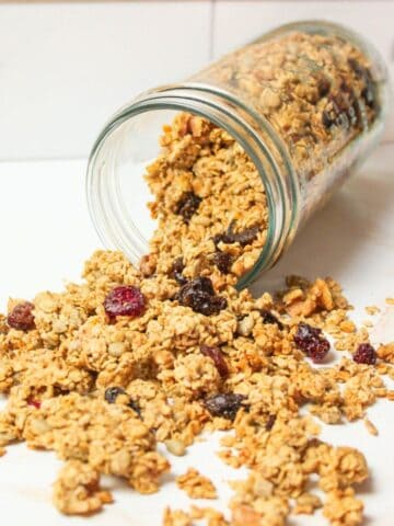 a jar spilling out homemade sourdough granola.