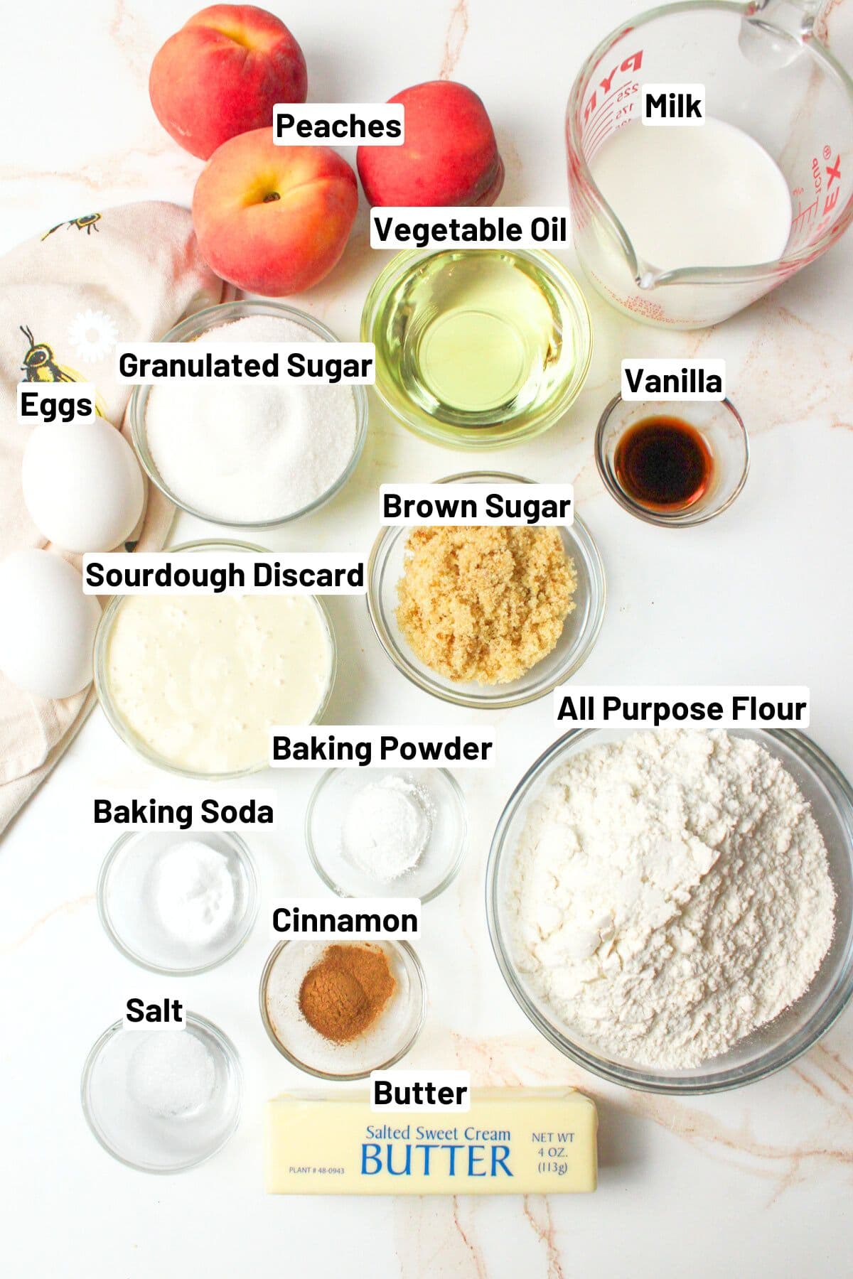 labeled ingredients needed to make sourdough peach coffee cake.