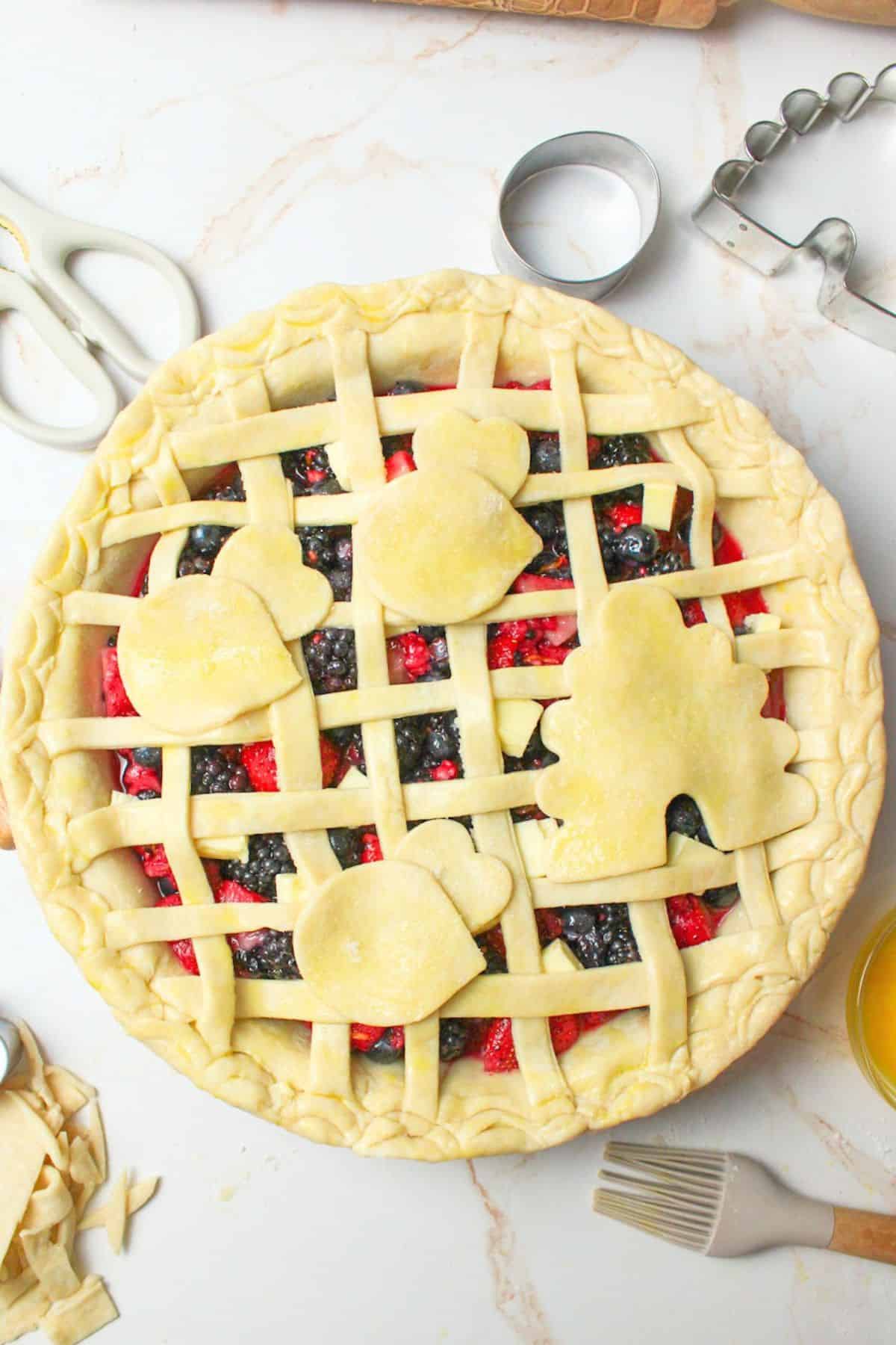 sourdough pie crust in a lattice and shapes on unbaked pie.