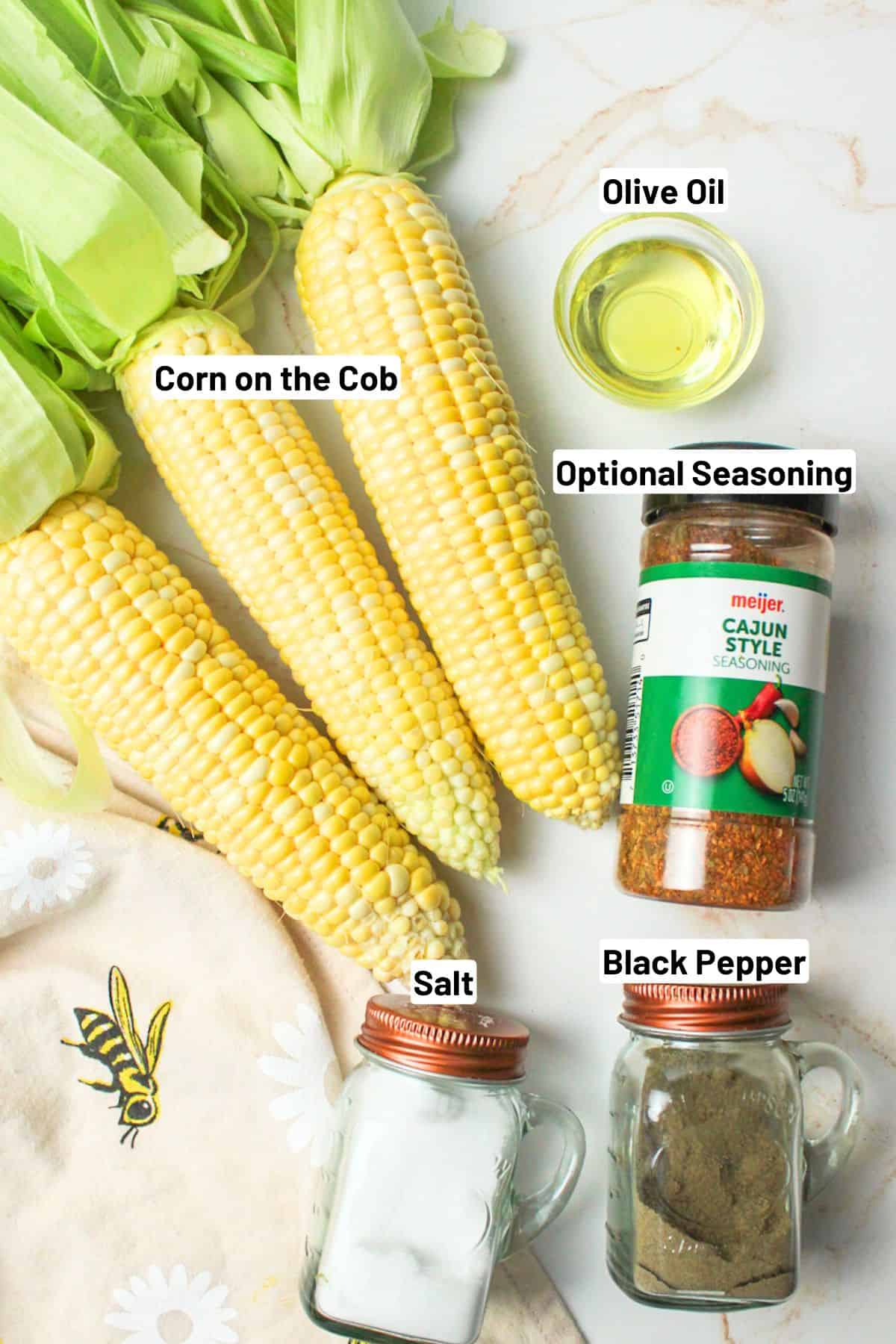 labeled ingredients needed to make air fryer corn on the cob.