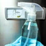 a bottle of stainless steel cleaner in front of dishwasher.