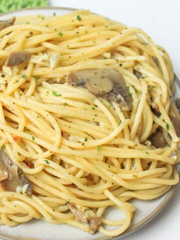 mushroom garlic spaghetti piled on a plate.