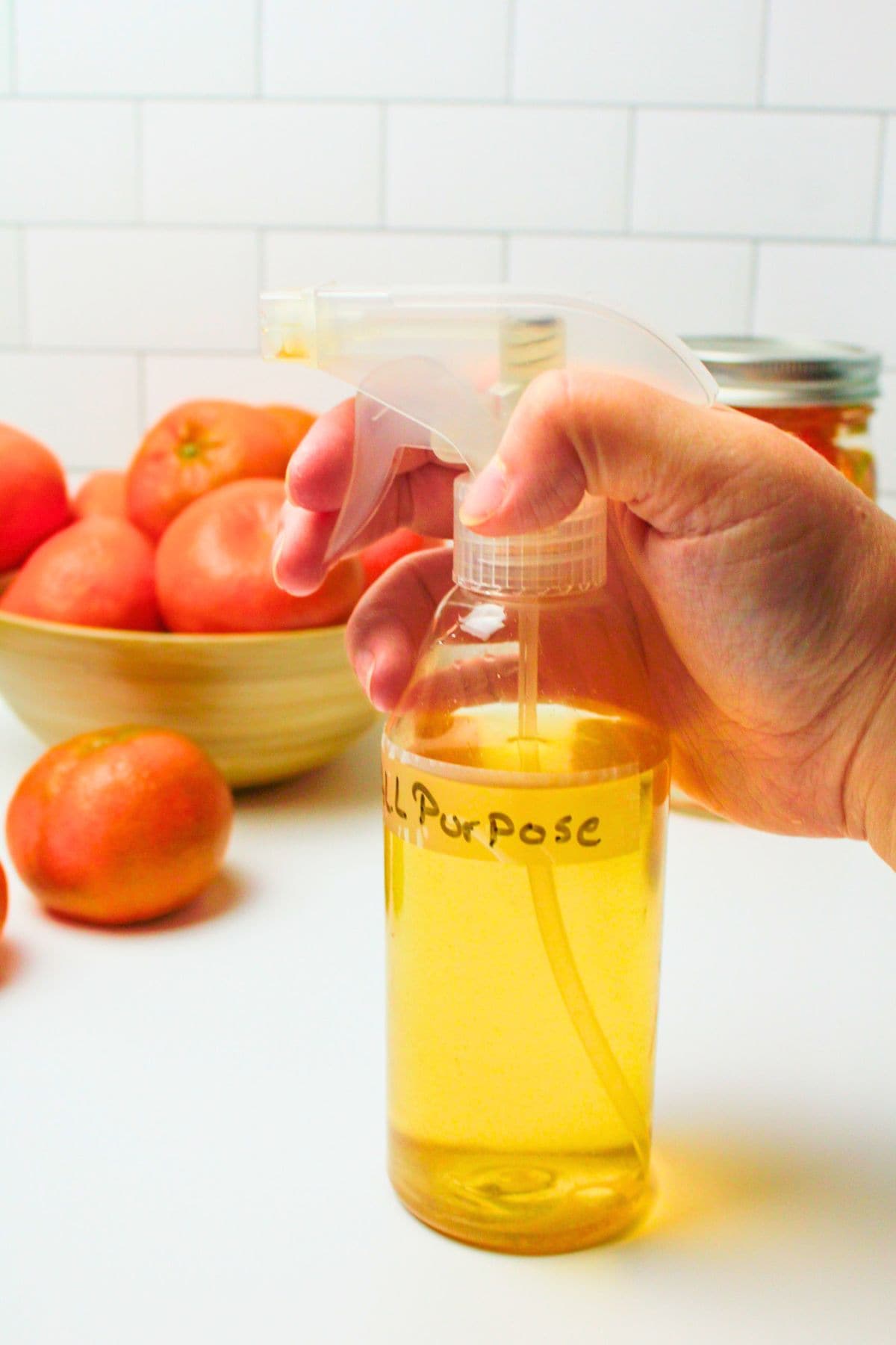 hand holding bottle of citrus all purpose cleaner.