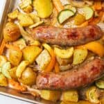 cooked bratwurst sheet pan meal on baking sheet.