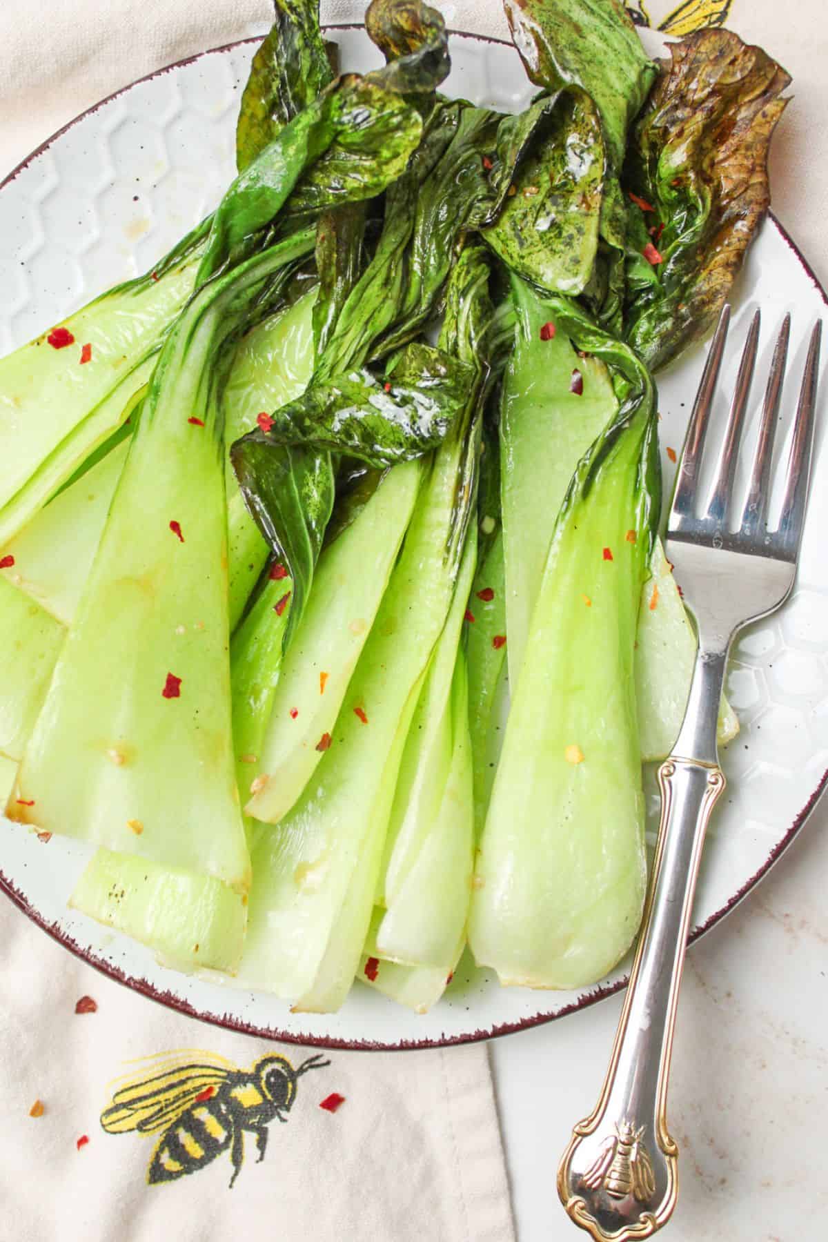 baby bok choy on a plate with a fork.