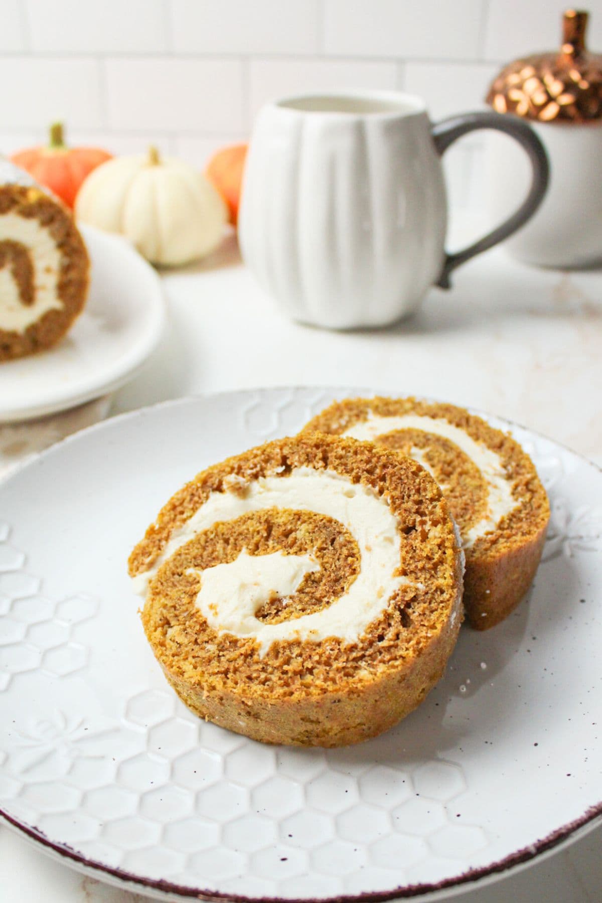 two slices of pumpkin roll on a plate.