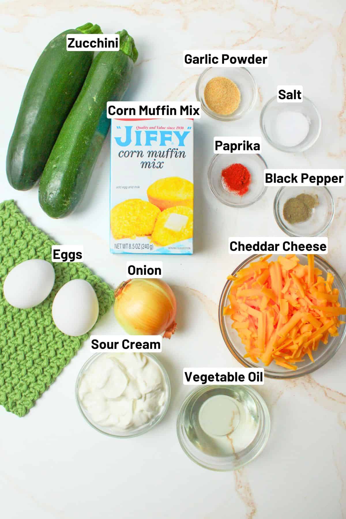 labeled ingredients for making zucchini cornbread casserole.