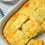 sliced zucchini cornbread casserole in a baking dish.