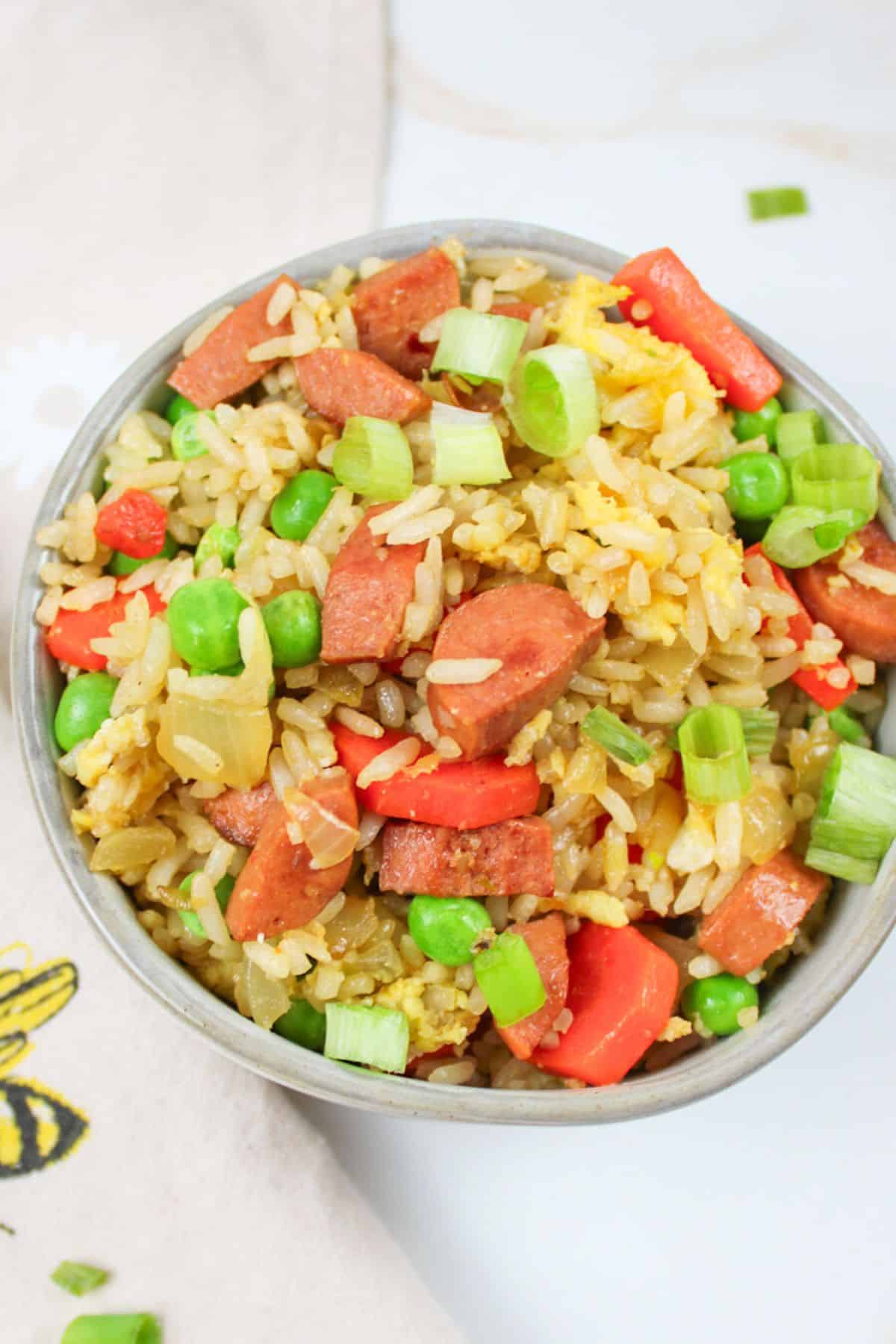 a bowl of hot dog fried rice.