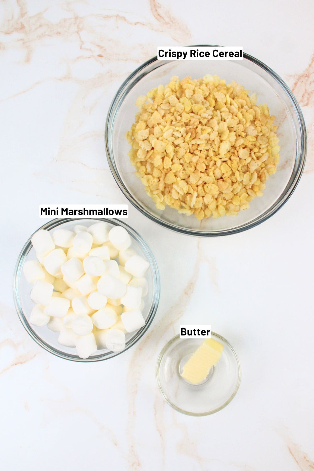 labeled ingredients needed to make rice krispie treat in a mug.