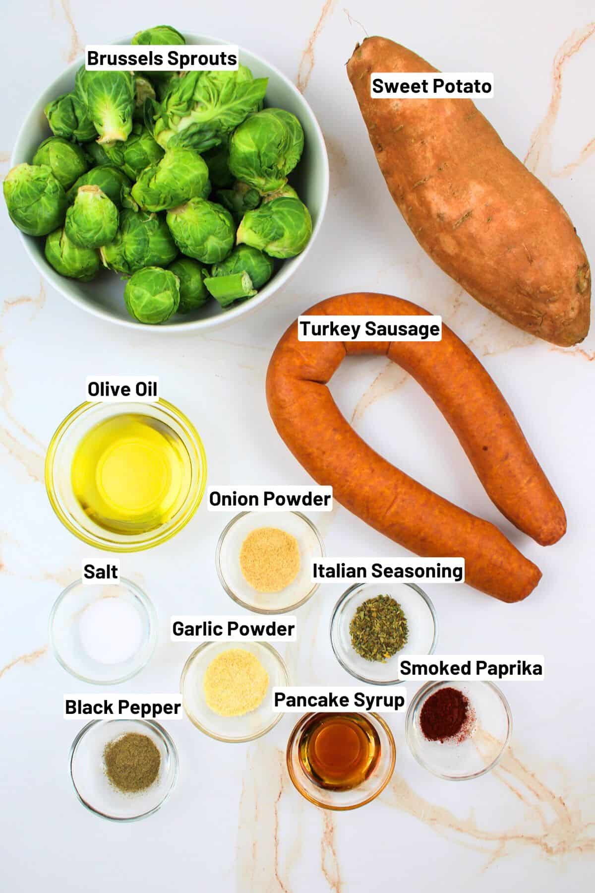 labeled ingredients for making sheet pan brussesl sprouts and sausages.