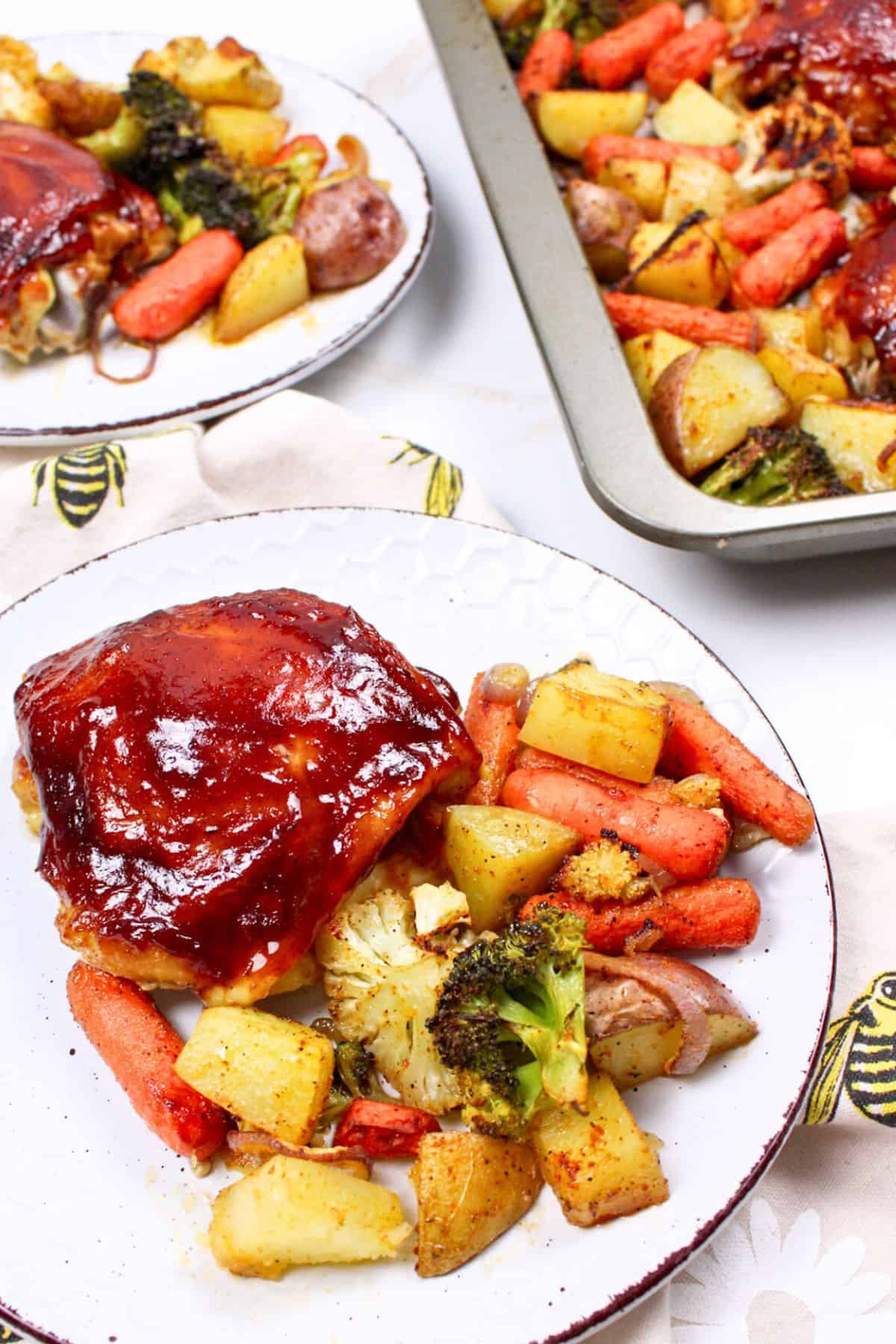 bbq chicken thigh with veggies on a plate.