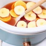slow cooker apple cider inside the crockpot.