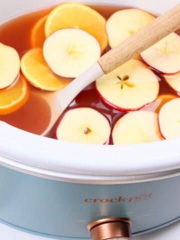 slow cooker apple cider inside the crockpot.