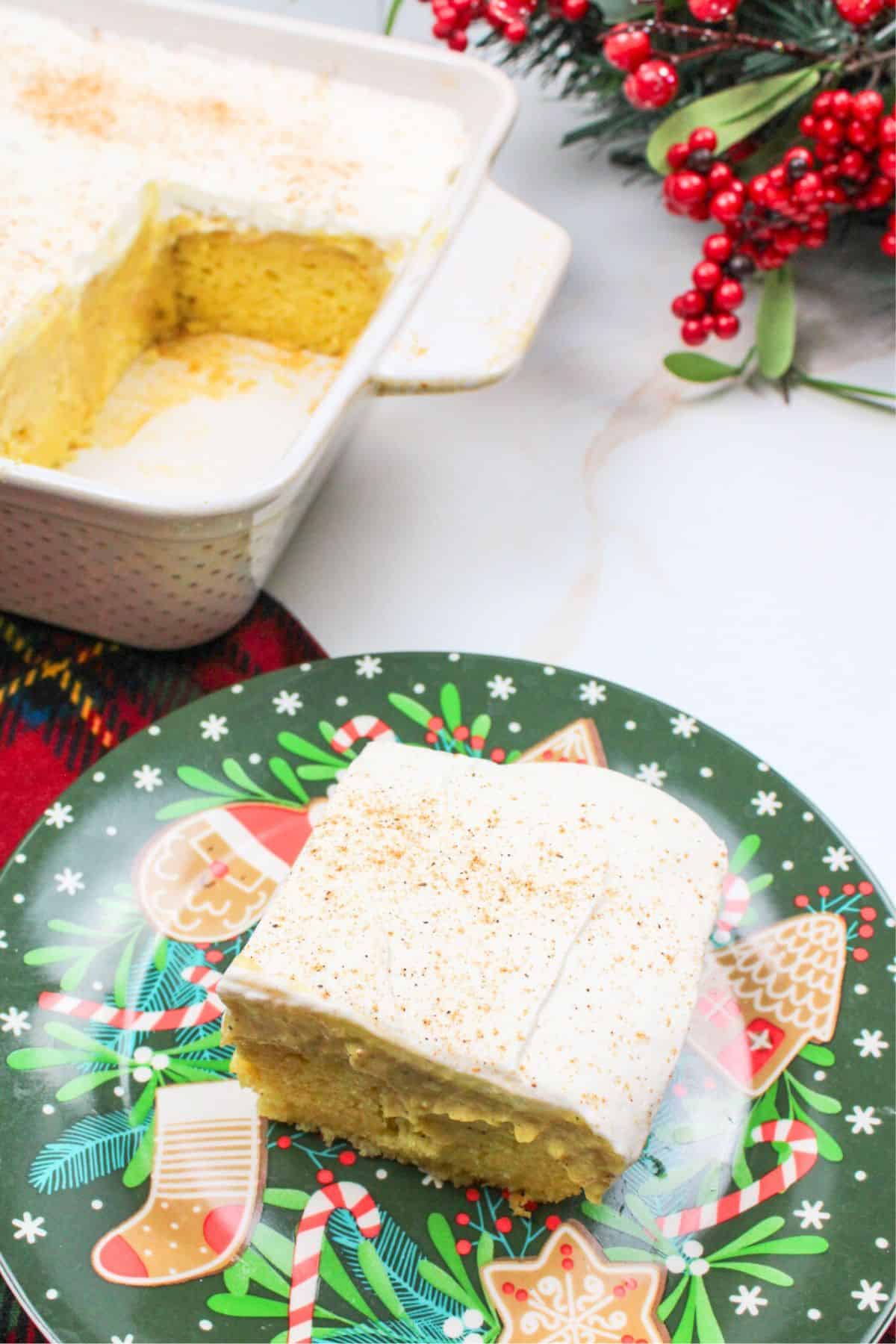 eggnog poke cake serving on a green plate.