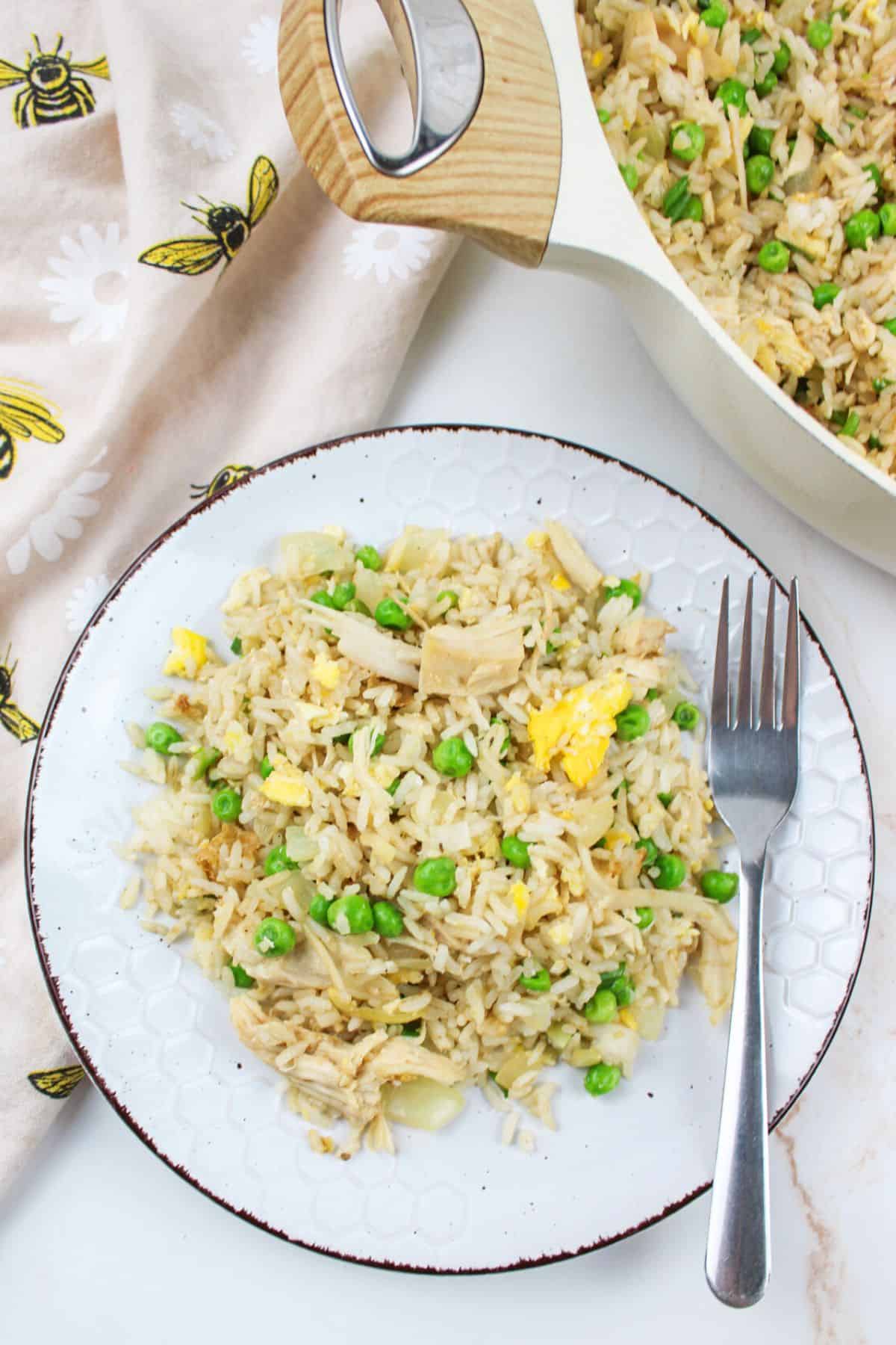 turkey fried rice on a plate with a fork.