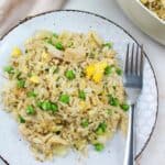 leftover turkey fried rice on a plate with a fork.