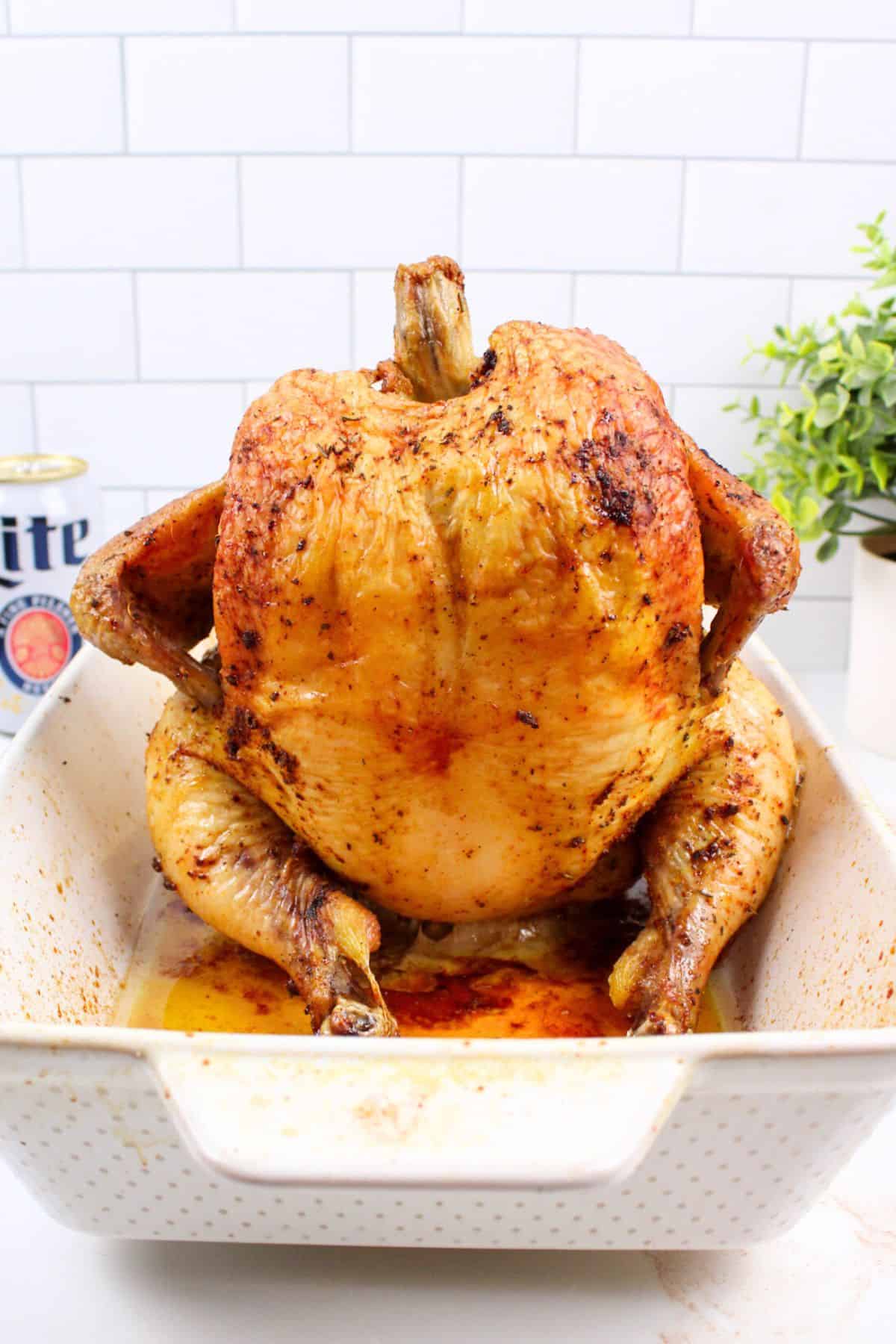 beer can chicken in a baking dish.