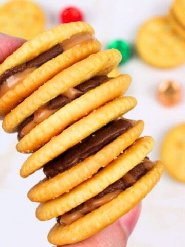 hand holding a stack of rolo stuffed ritz crackers.